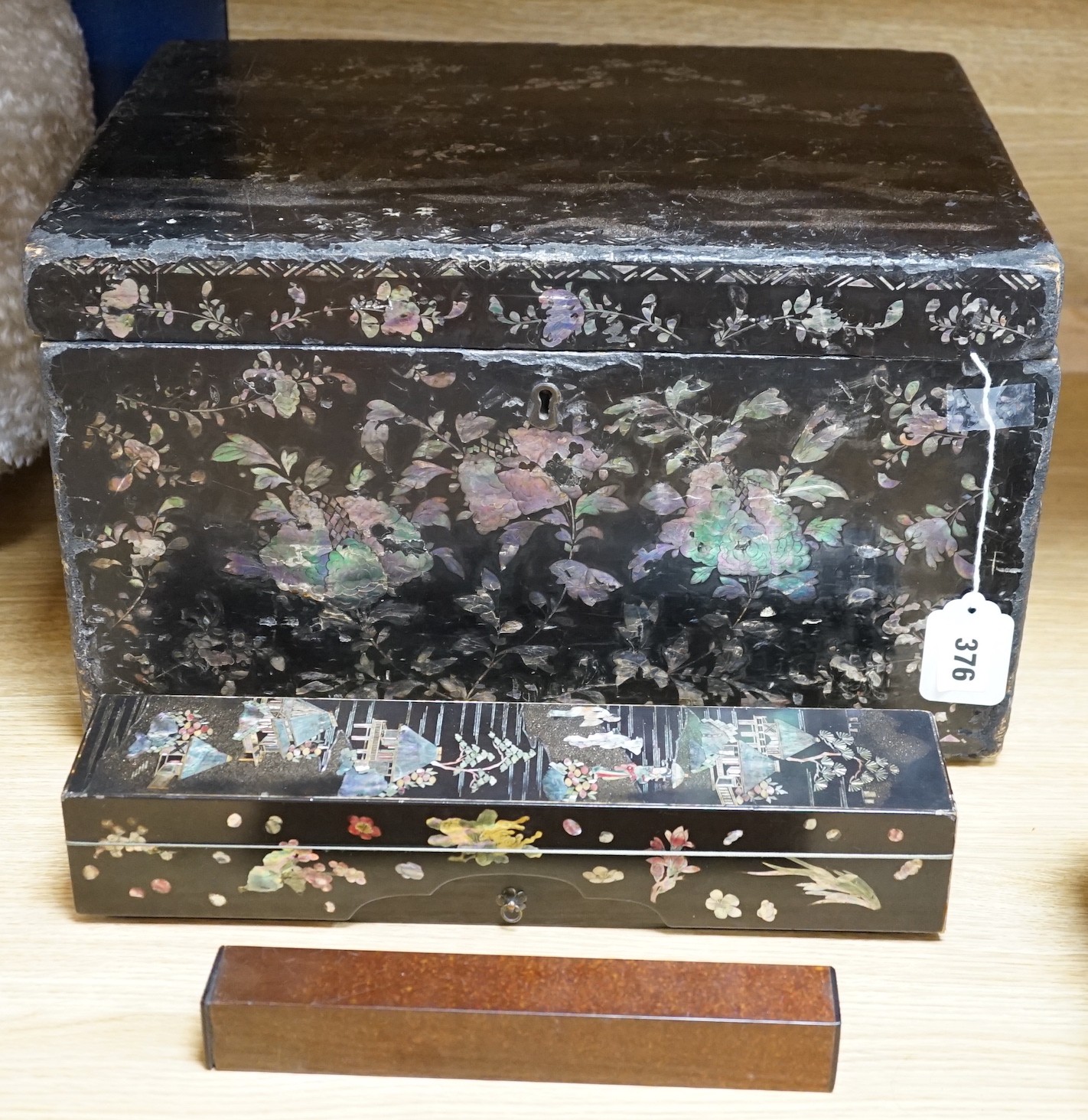 A late 19th century Chinese lacquer box, two smaller Japanese lacquer boxes, a doll, a collection of later paper fans etc, Chinese box 24cms high x 42cms wide